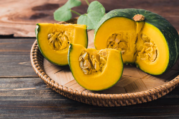 istock Green pumpkin on wooden background 1415082180