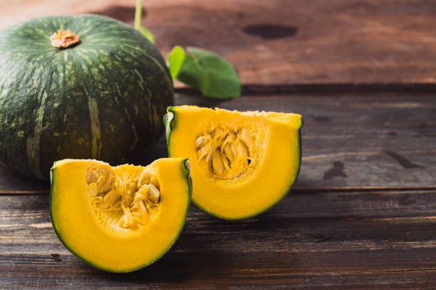 istock Green pumpkin on wooden background 1415082194