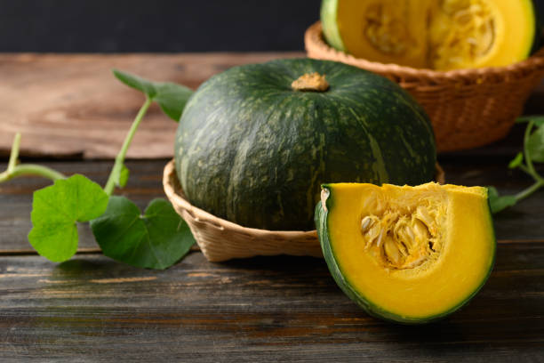 istock Green pumpkin on wooden background 1415082195