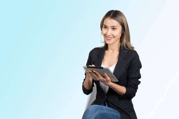 istock Business woman sitting on chair while working on digital tablet device. 1415083915