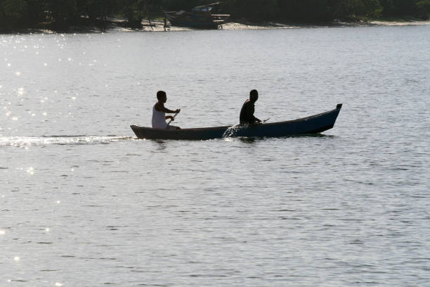 A tranquil scene of a canoe floating on still water, reflecting surrounding greenery. This image evokes feelings of peace and relaxation in nature.