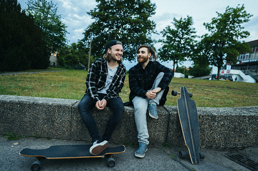 They relax on a cement wall and chat