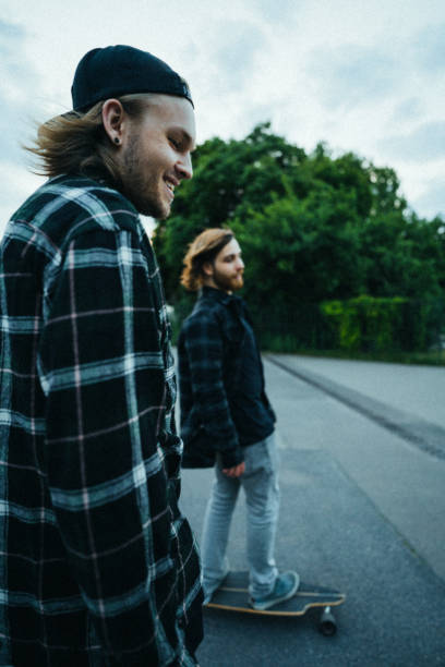 Two young men in the  city with longboards