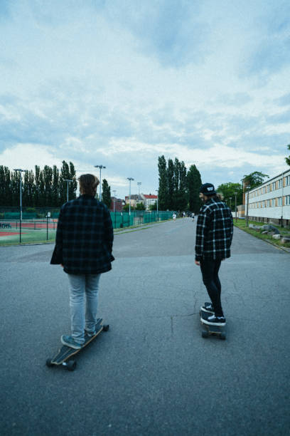 istock Two young men in the  city with longboards 1415092762