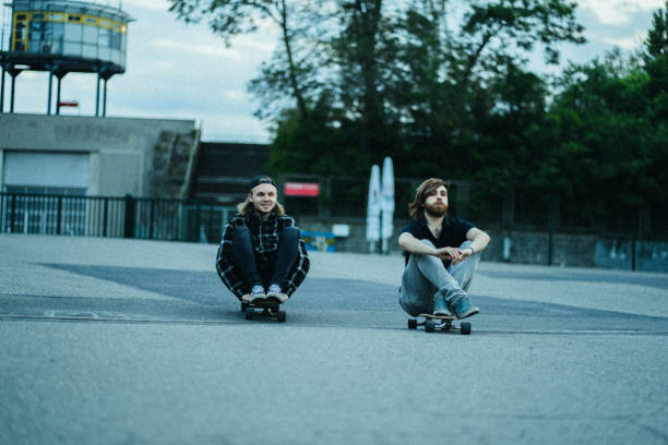 istock Two young men in the  city with longboards 1415092831