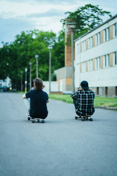 Two young men in the  city with longboards