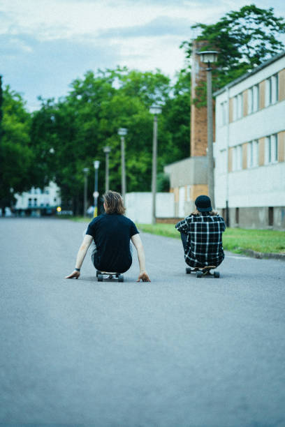 istock Two young men in the  city with longboards 1415092848