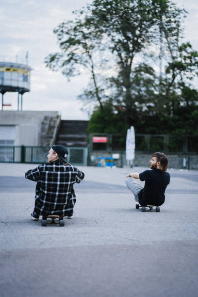 istock Two young men in the  city with longboards 1415092869