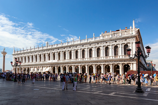 Venice, Italy - July 23, 2012: Tourists stays in the long line on the Piazza San Marko in Venice to visit the Saint Mark's Cathedral,  Campanile di San Marco (bell tower) and Dodge's Palace.
