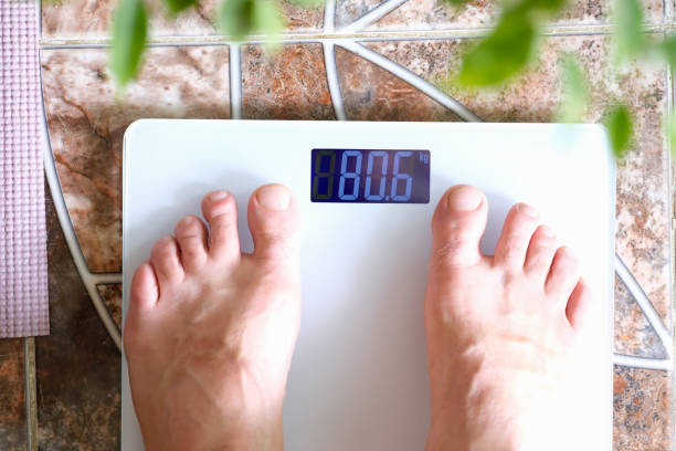 istock Man stands on scales on scales figure 80 kilograms 1415098697