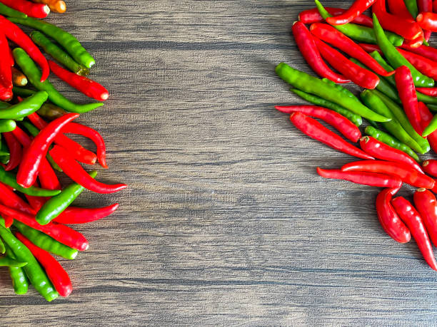 istock Fresh red chili and space for text on wooden background 1415101685