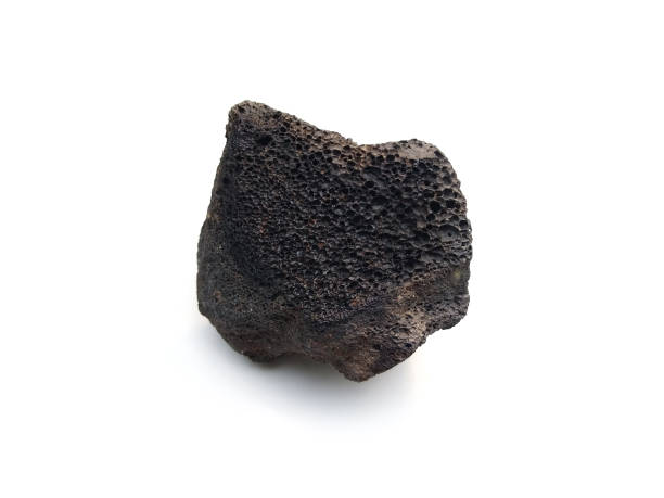 istock Aquarium stone, black grey lava rock isolated on white background, selective focus 1415104827