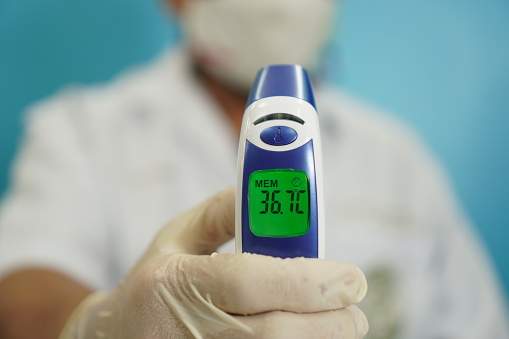 Image: Digital infrared thermometer, close-up, medical equipment.