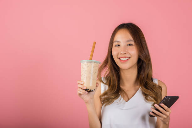istock woman holding drinking brown sugar flavored tapioca pearl bubble milk tea 1415108861