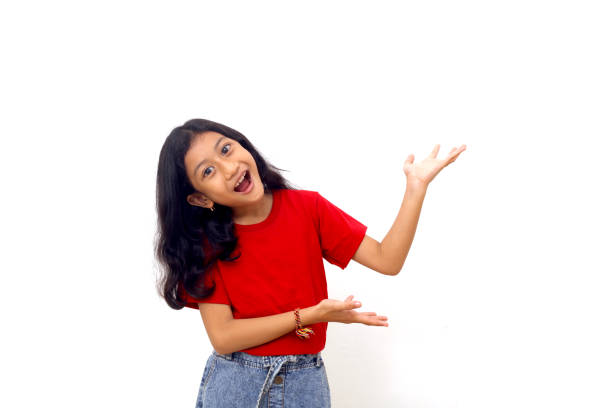 istock Wow and amazed expression of asian little girl while presenting something on empty space. 1415111084