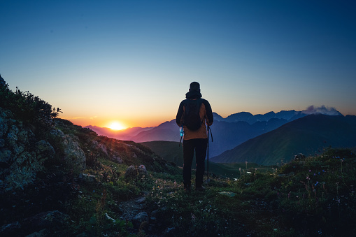 Silhouette of hiker in the mountains at sunset