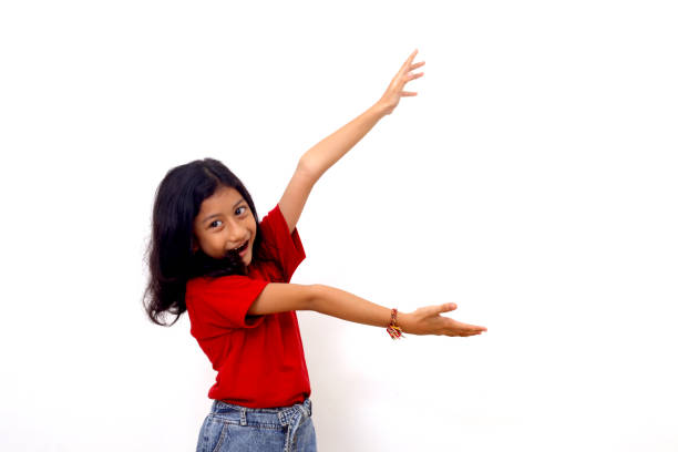 Wow and amazed expression of asian little girl while presenting something on empty space