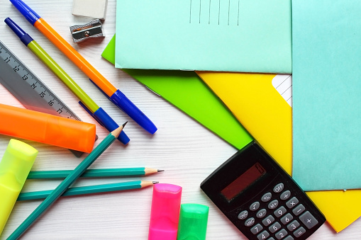 School supplies, stationery items on a gray background.