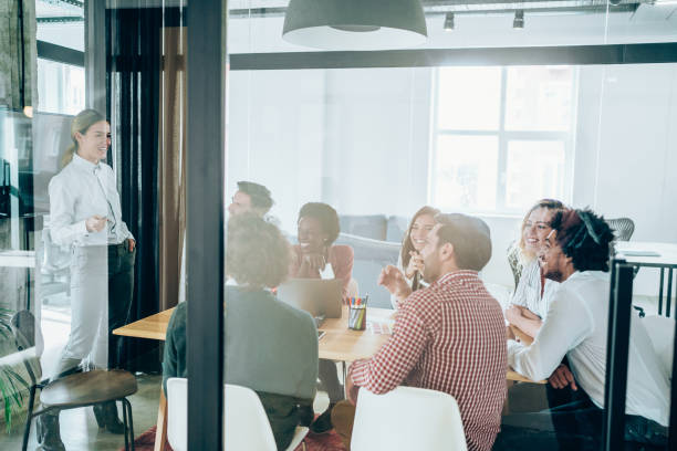 istock Confident businesswoman discussing with colleagues. 1415121709