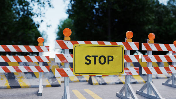 istock stop sign with traffic barrier on road, 3d rendering 1415124499