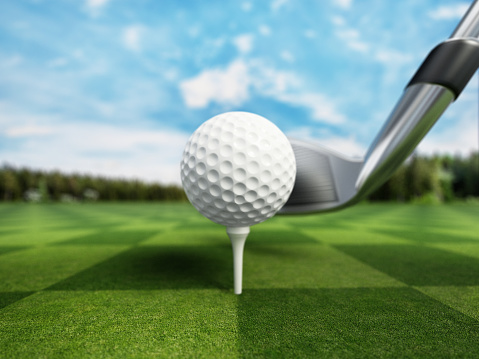 golf clubs and balls on grass
