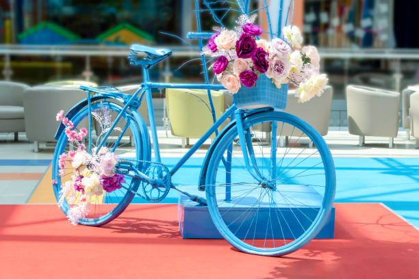 istock Decorative vintage blue bicycle with flowers 1415126656