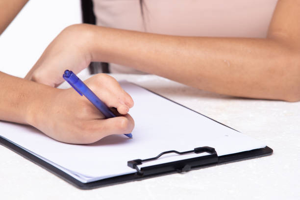istock Disabled person hand without fingers since childhood brith, using pen to write word sentence on paper note. Woman use short fingers to hold pen as normal people, white background isolated copy space 1415130855