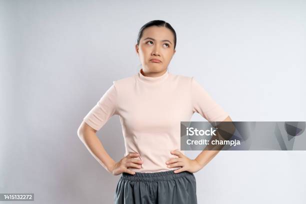Asian Woman Shrugs Her Arms And Makes Gesturing Of She Dont Know Isolated Over White Background Stock Photo - Download Image Now