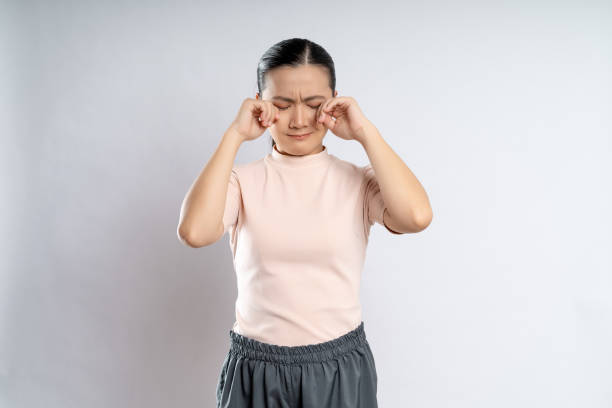 istock Asian woman sad and crying isolated on background. 1415132420