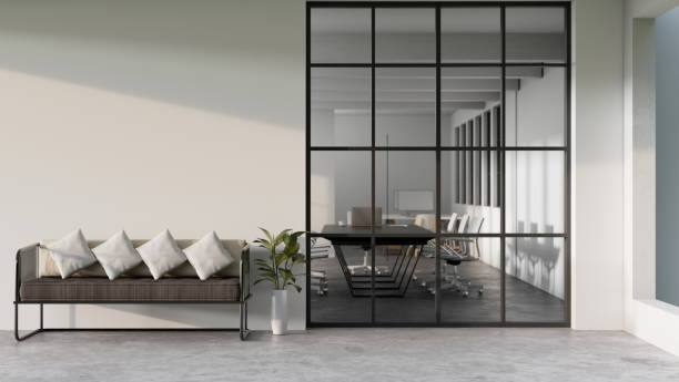 istock Modern loft office corridor or hallway interior with sofa and a large window with meeting room 1415132439