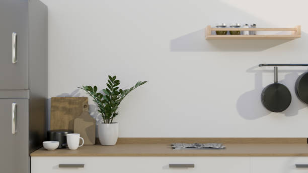 istock A modern wooden kitchen tabletop with kitchenware and copy space over the white wall. close-up image. 1415132468