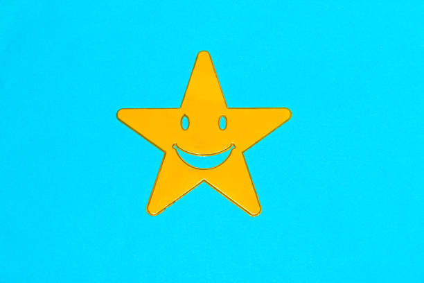istock yellow smiling star on blue background, creative art modern design 1415133367