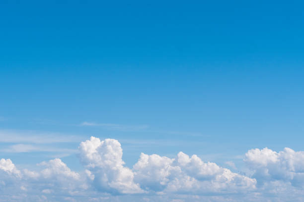 istock image of white clouds in blue sky 1415134556