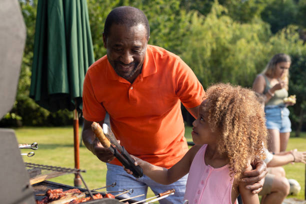 istock Helping Cook on the Barbecue 1415136152