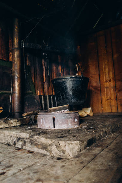 istock A large vat in which cheese is cooked over an open fire. The cauldron is prepared over an open wood fire. Cheese factory in the mountains. 1415136192
