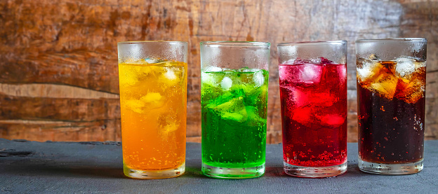 A lot of Soft drinks in colorful and flavorful glasses on the table,Glasses with sweet drinks with ice cubes