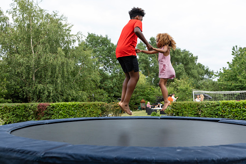 Single Parent Mother having fun with her son on the trampoline