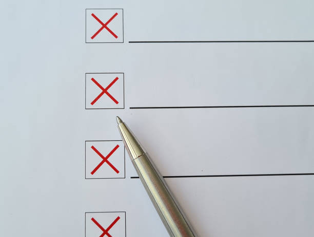 Ballpoint pen crosses off checklist items with a red X on white paper Ballpoint pen crosses off checklist items with a red X on white paper. Test and failure concept cross off stock pictures, royalty-free photos & images