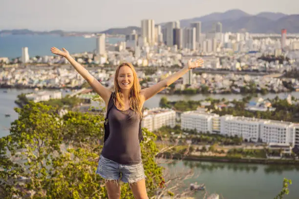 Photo of Woman tourist on the background of Nha Trang city. Travel to Vietnam Concept