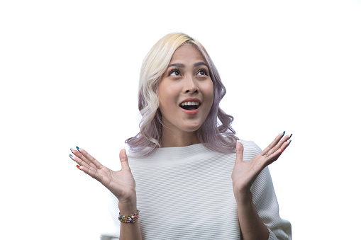 Surprised young Asian woman shouting over white background.