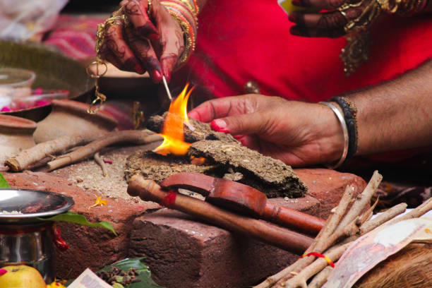 istock Hawan/Pooja Items/Process: Lighting the cow dung for hawan 1415140838