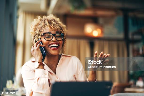 Smiling Businesswoman Talking On A Mobile Phone In The Cafe Stock Photo - Download Image Now