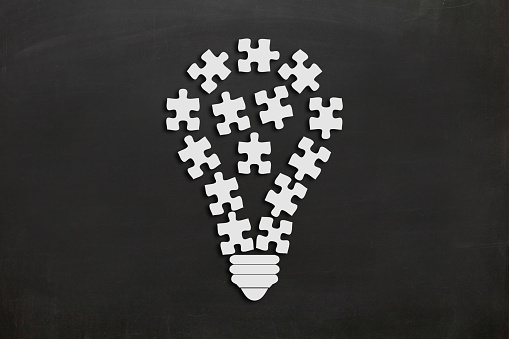 Idea puzzle light bulb teamwork brainstorming solution