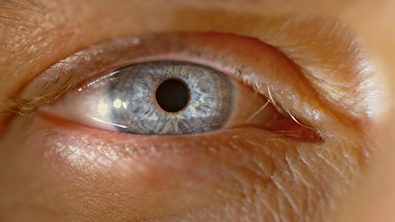 Extreme close-up of man's blue eye.