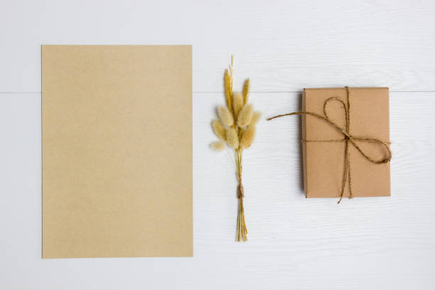 istock Brown letter with gift box over the white wooden background. 1415145156