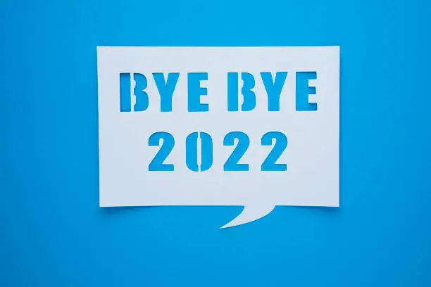 Bye bye 2022 on blue paper background. Hello, Hope and New year time concept