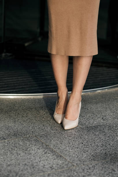 istock women legs with nude shoes 1415145343