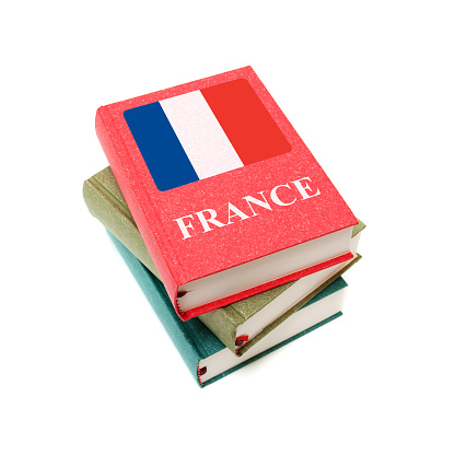 Stack of books with flag of France isolated on white background
