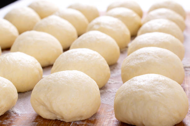 Yeast dough balls on the wooden board
