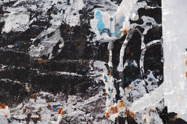 istock Torn and abstract street poster background on a black wall 1415151574